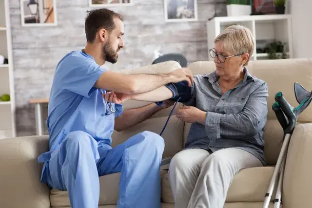Registered nurse providing compassionate community nursing care to an NDIS participant at home - Ekaa Care