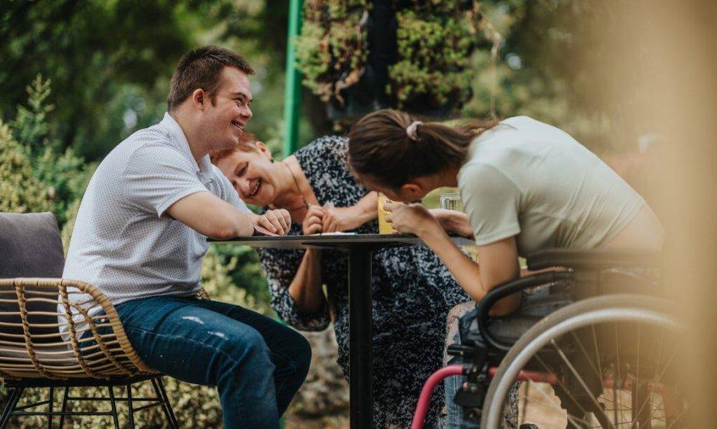 NDIS participant engaging in a group social activity during a community participation session